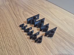 Клипси за кабели, черен вариант на дървена повърхност